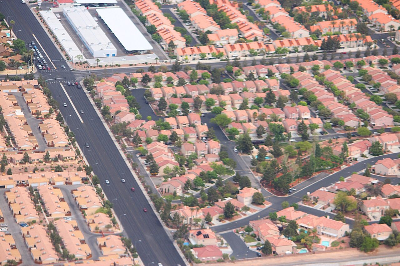 Aerial view of a Las Vegas suburban housing tract, rows of single-storey homes with walled backyards