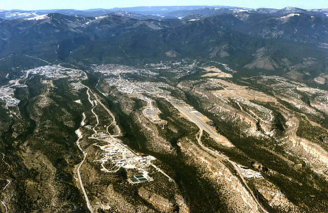 Aerial view from the south-west of Los Alamos National Laboratory buildings on the mesas, with the Los Alamos townsite beyond