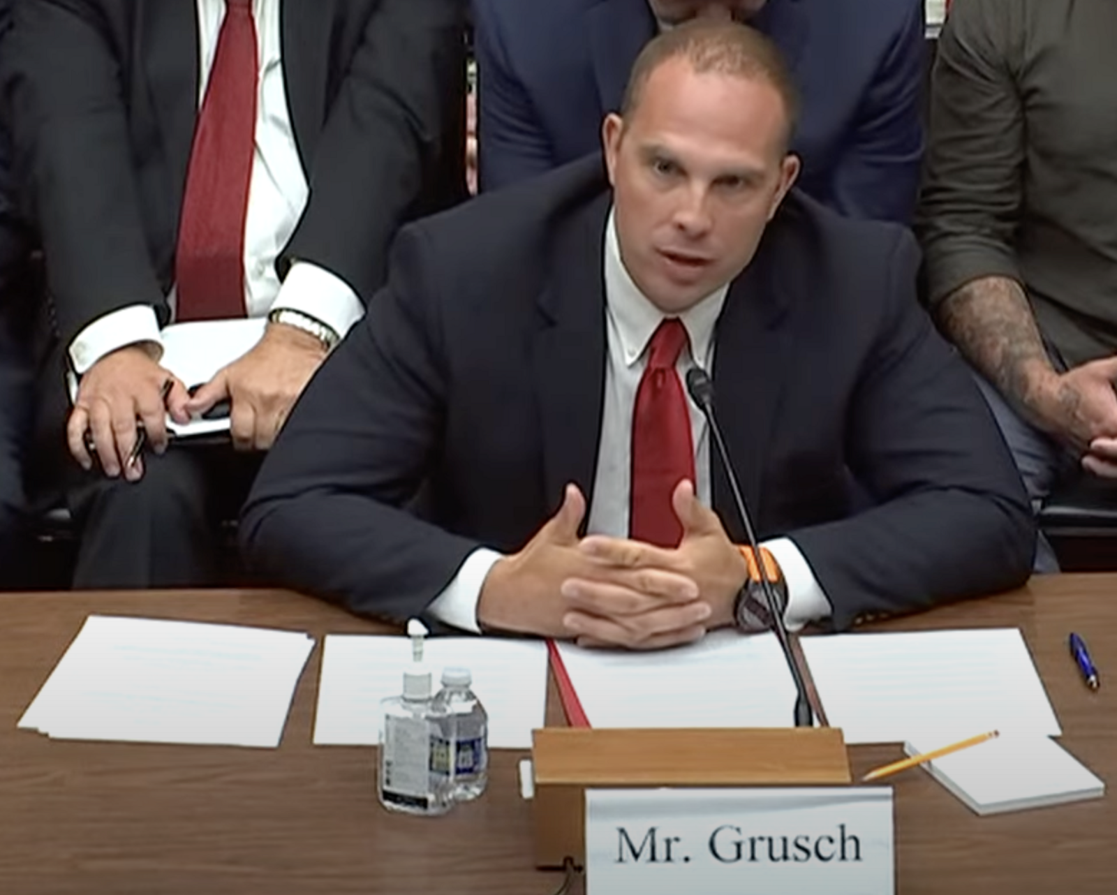 David Grusch seated at a witness table giving sworn testimony before a US House subcommittee on 26 July 2023