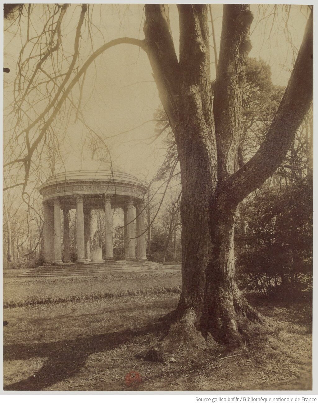 Early photograph of the Temple de l'Amour, a circular colonnaded garden building on a low mound at the Petit Trianon, Versailles.
