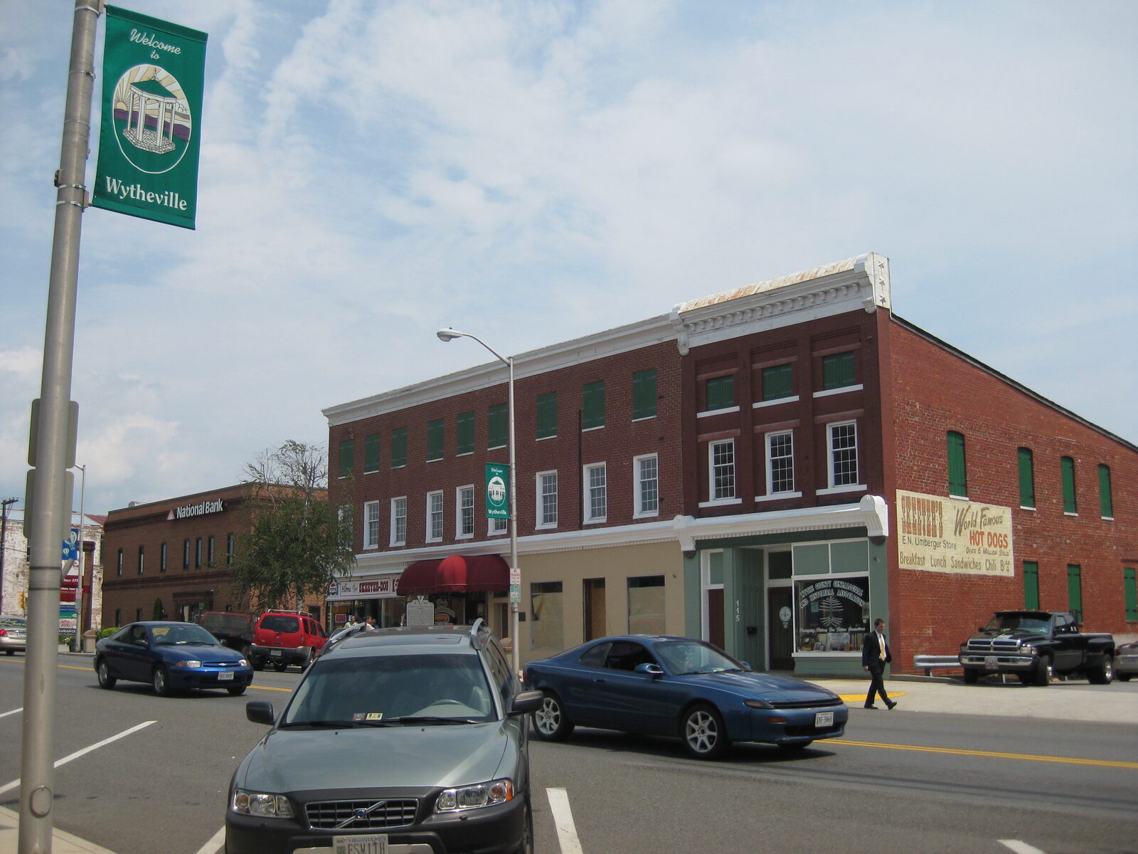 Main Street in the small town of Wytheville, Virginia, lined with low brick commercial buildings under a clear sky.